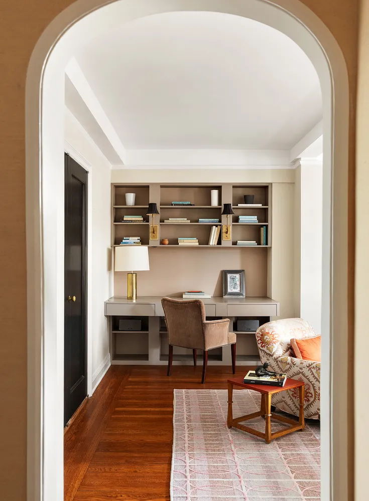 a living room with furniture and lamp