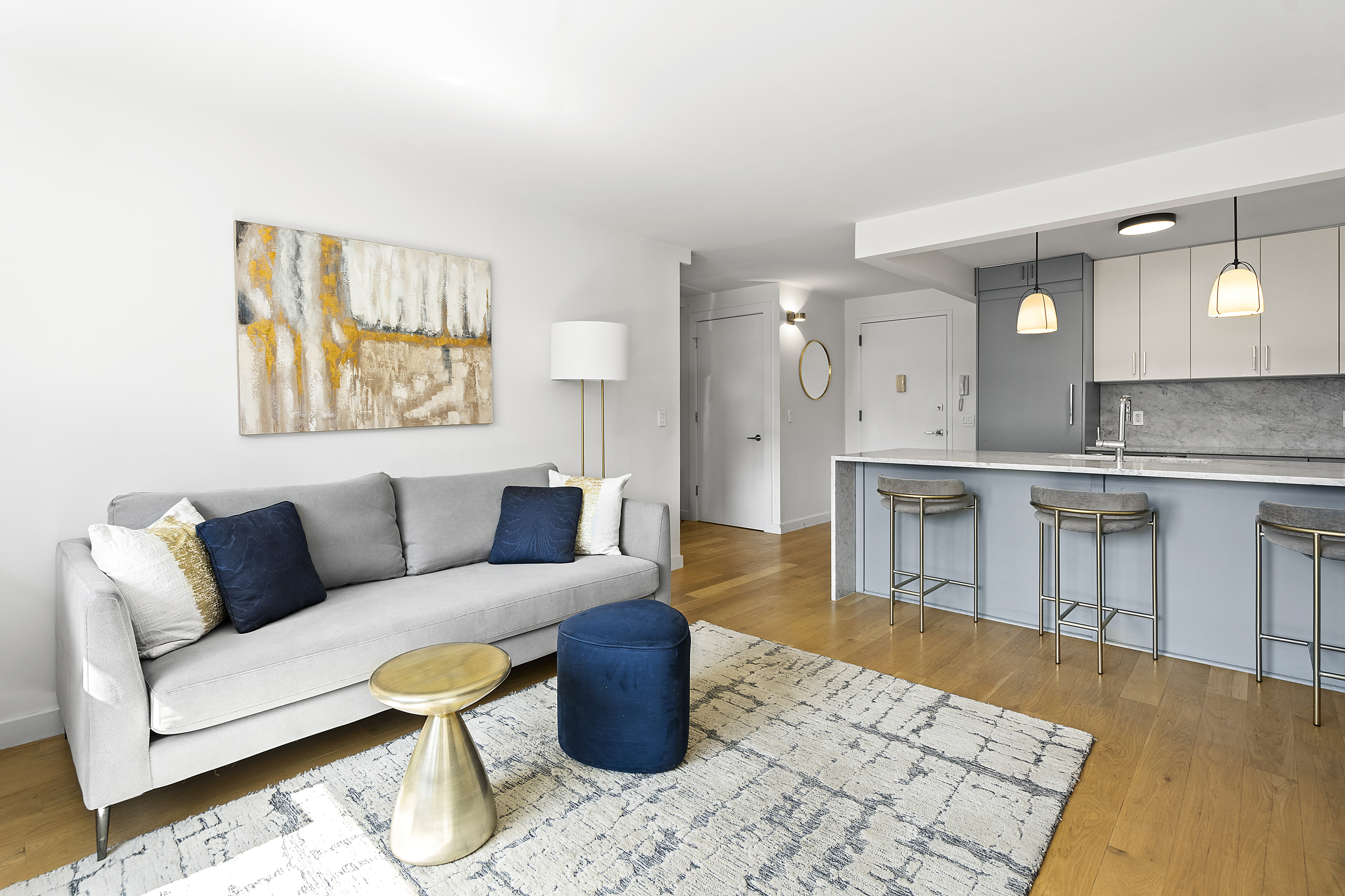 1330 5th Avenue, Unit 6H Manhattan, NY 10026 - Photo 2 of 11 a living room with furniture and a kitchen view
