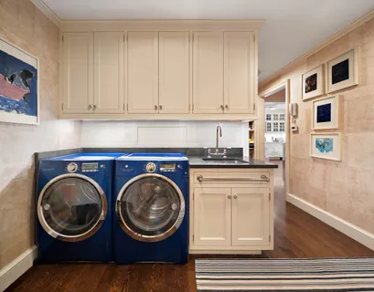 a kitchen with stainless steel appliances granite countertop white cabinets and a stove top oven