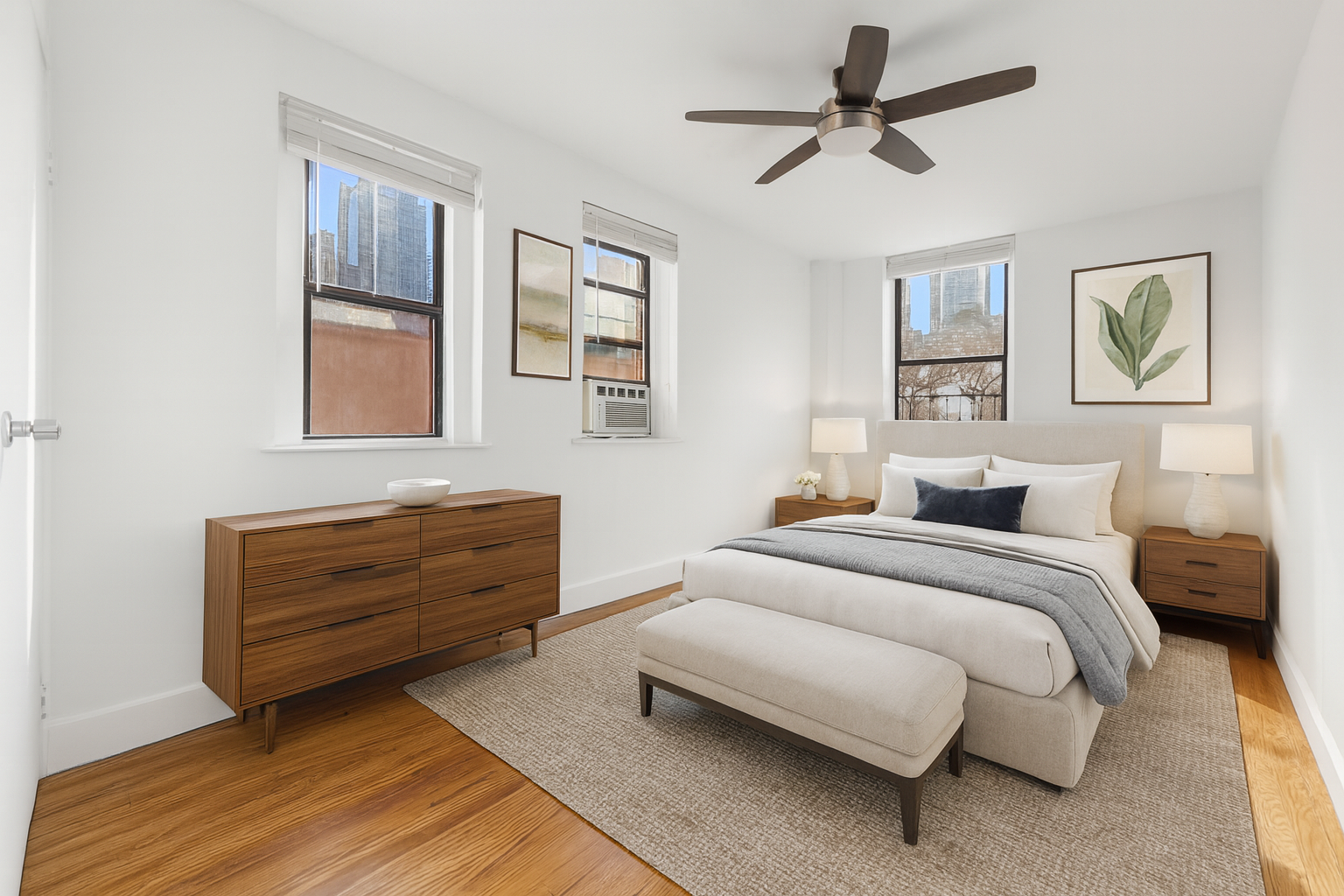 406 West 47th Street, Unit 2D Manhattan, NY 10036 - Photo 3 of 7 a bed room with a bed and a window