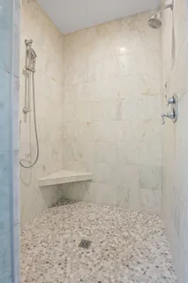 a spacious bathroom with a bathtub and next to a window