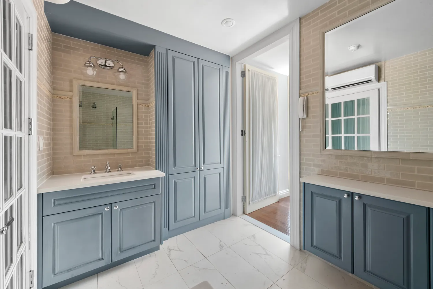 a spacious bathroom with a granite countertop sink and mirror with bathtub