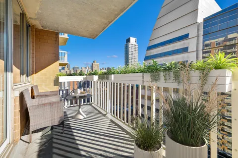 a view of a chair and tables in the balcony
