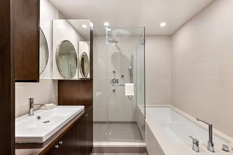 a bathroom with a bathtub a sink and a mirror