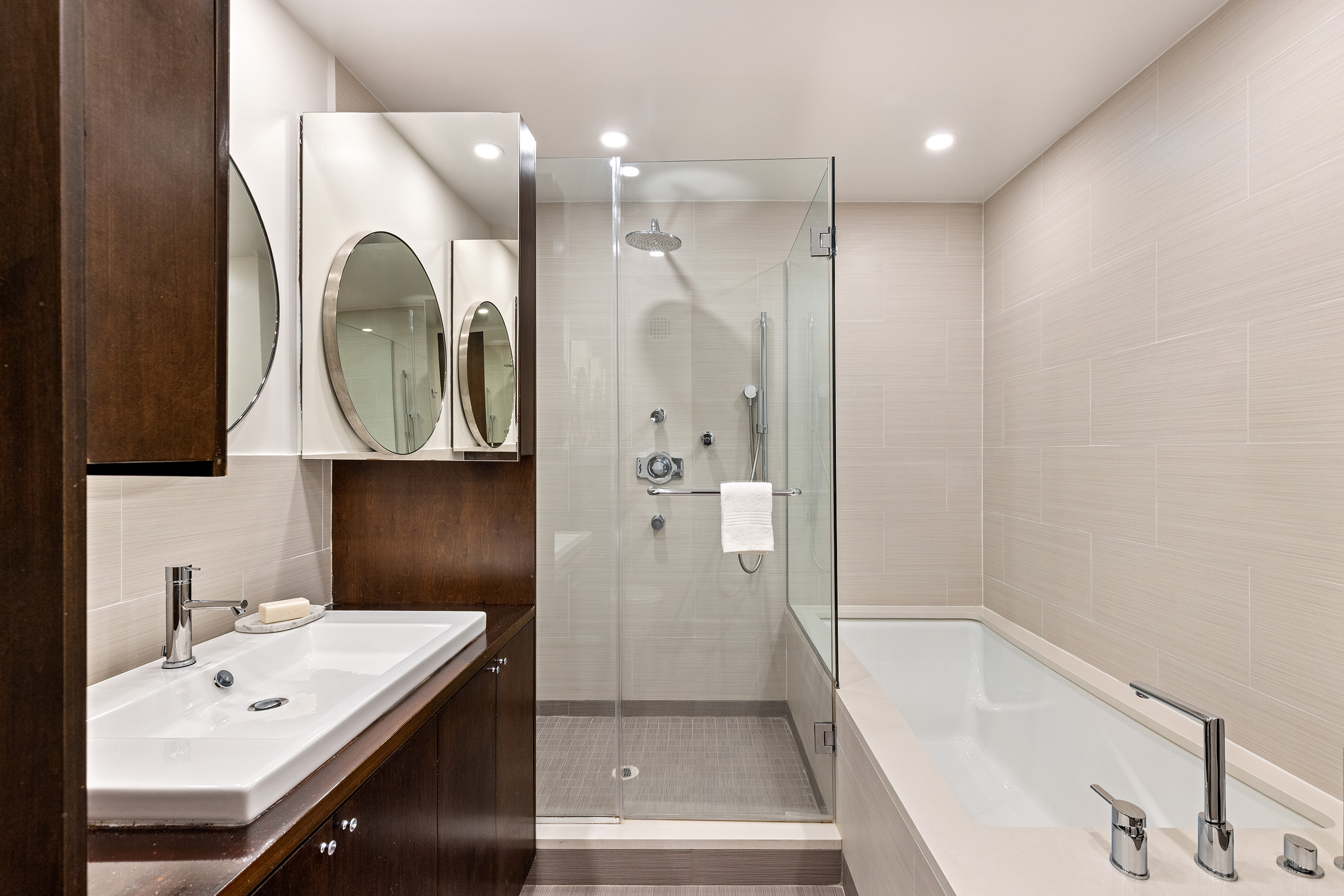 333 West 22nd Street, Unit 5A Manhattan, NY 10011 - Photo 6 of 12 a bathroom with a bathtub a sink and a mirror