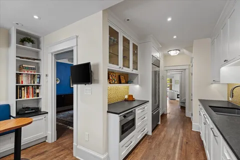 a living room with furniture wooden floor and a flat screen tv