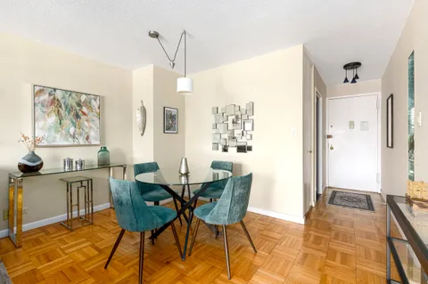 a view of a dining room with furniture and a rug
