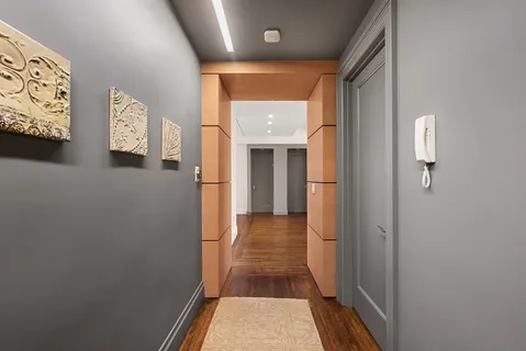 a view of a hallway with wooden floor