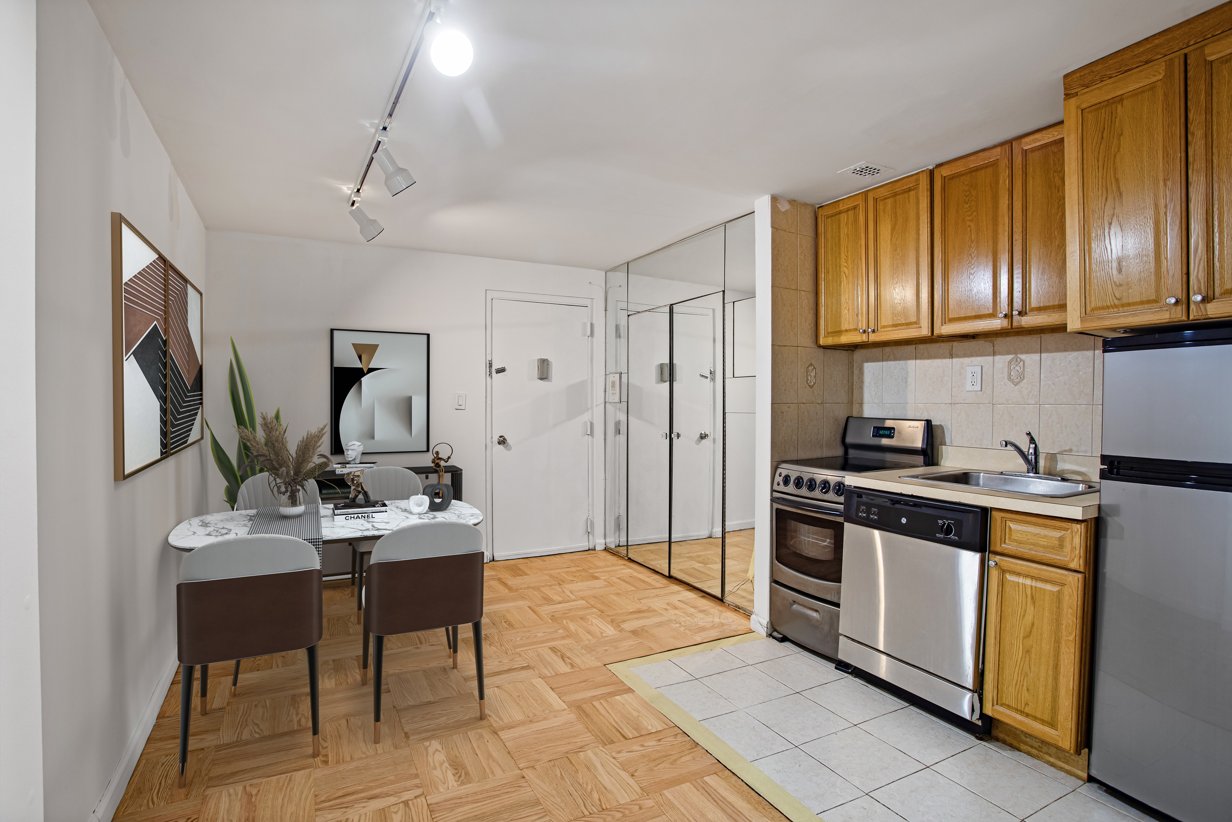 435 East 86th Street, Unit 2C Manhattan, NY 10028 - Photo 4 of 10 a kitchen with stainless steel appliances granite countertop a stove refrigerator and cabinets