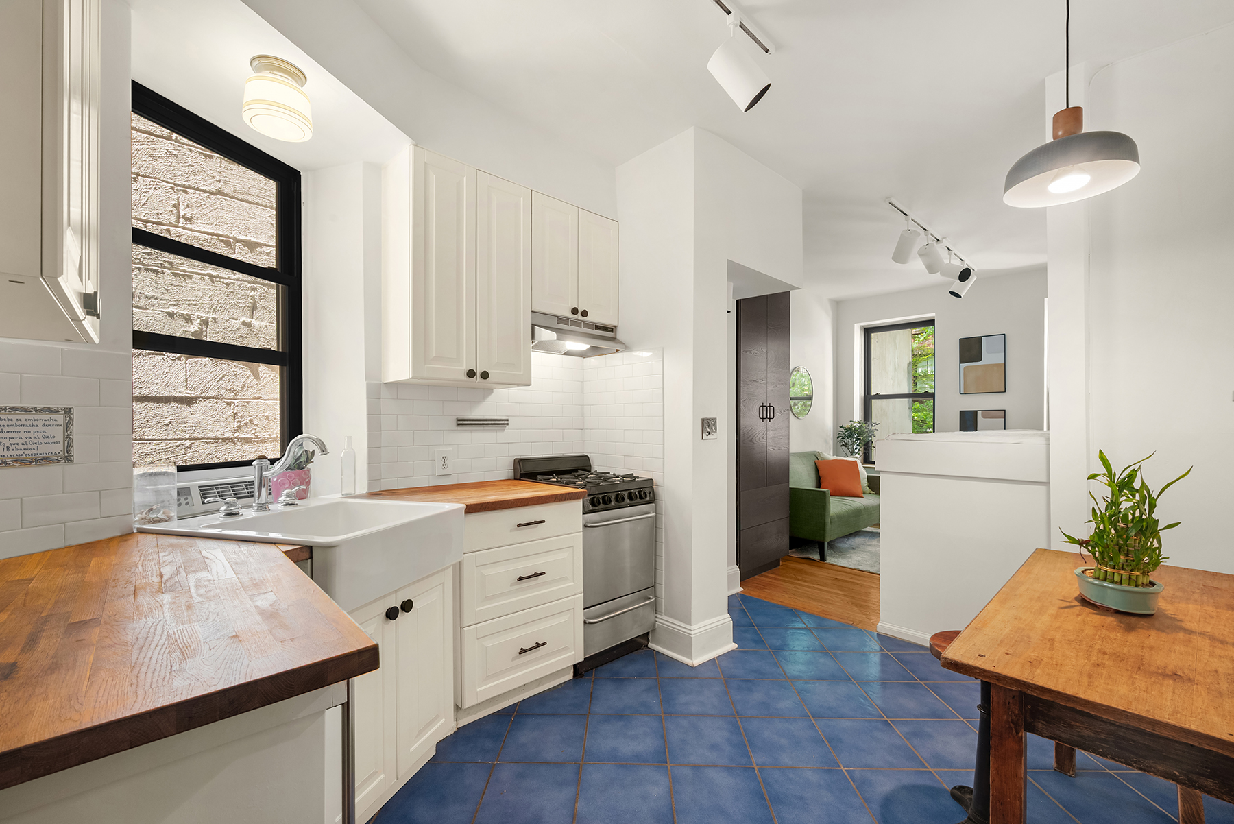 41 Perry Street, Unit 2A Manhattan, NY 10014 - Photo 6 of 12 a kitchen with a sink stove and cabinets