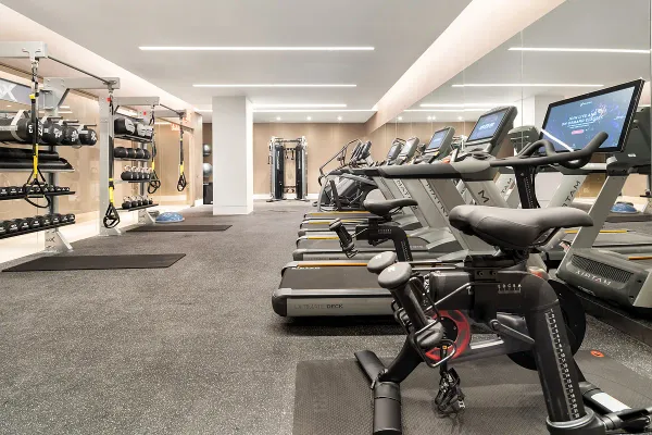 a room with gym equipment and air hockey table