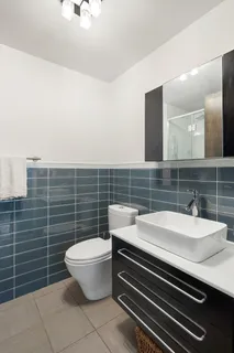 a bathroom with a toilet a sink and a mirror