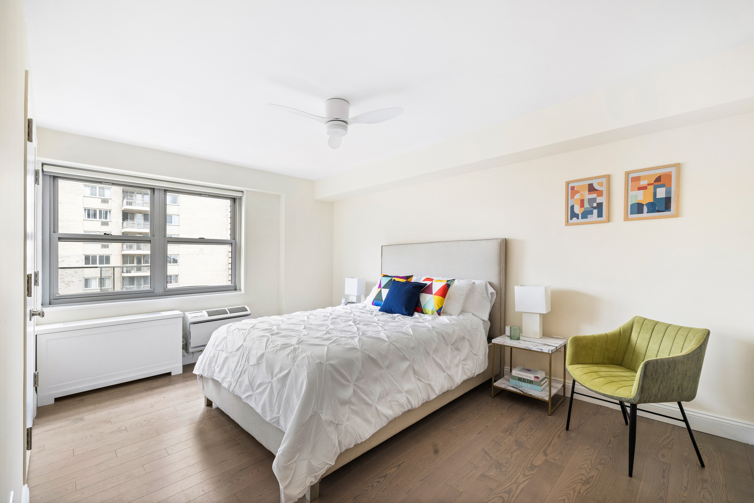 100 West 93rd Street, Unit 11J Manhattan, NY 10025 - Photo 5 of 13 a bedroom with a bed chair and a window