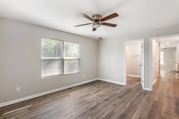 wooden floor in an empty room with a window