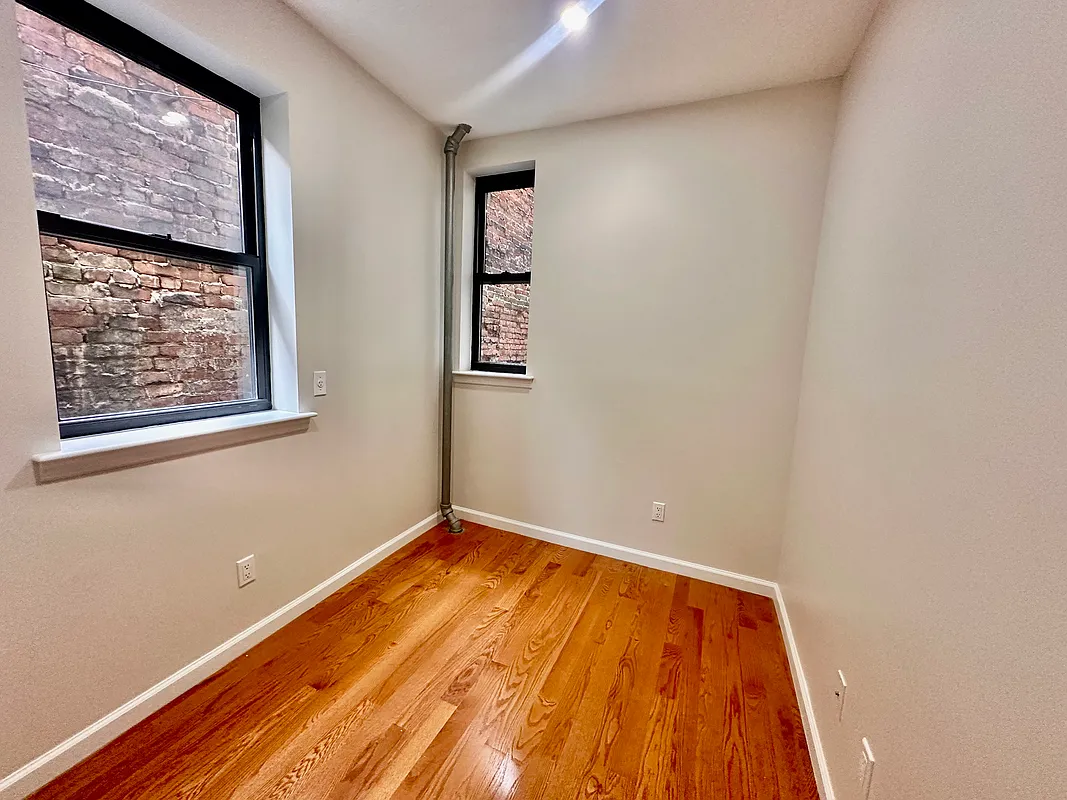 22 St Marks Place, Unit 16 Manhattan, NY 10003 - Photo 5 of 5 a view of a room with wooden floor and wall painting