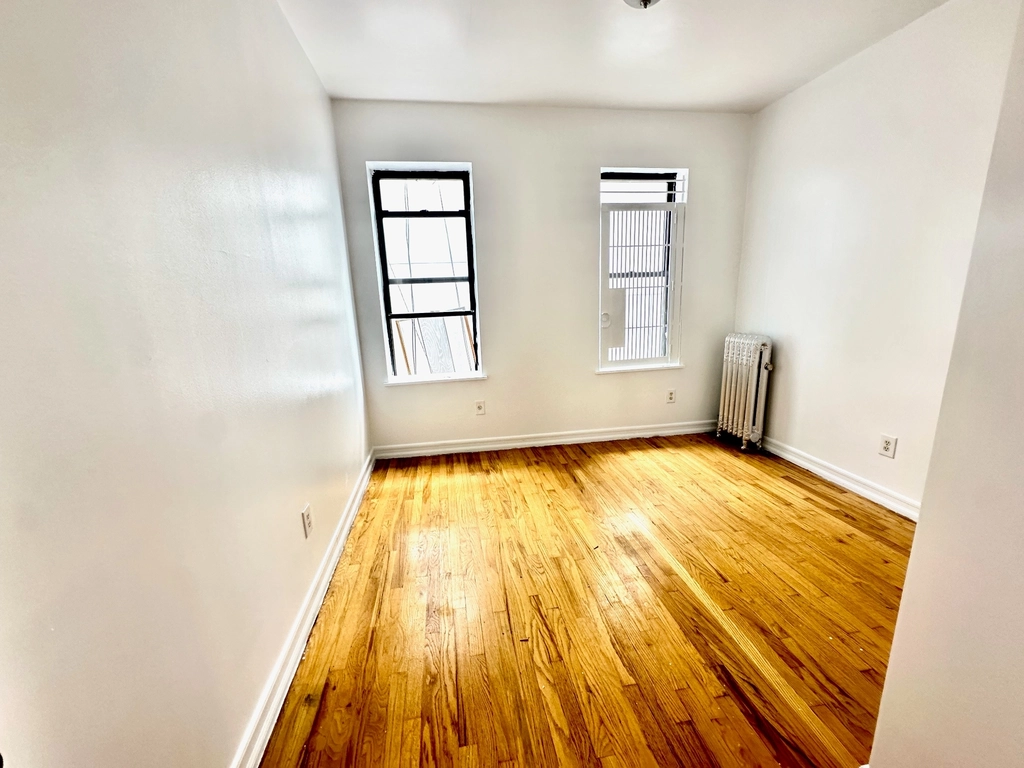 3694 Broadway, Unit 4F Manhattan, NY 10031 - Photo 2 of 4 wooden floor in an empty room with a window
