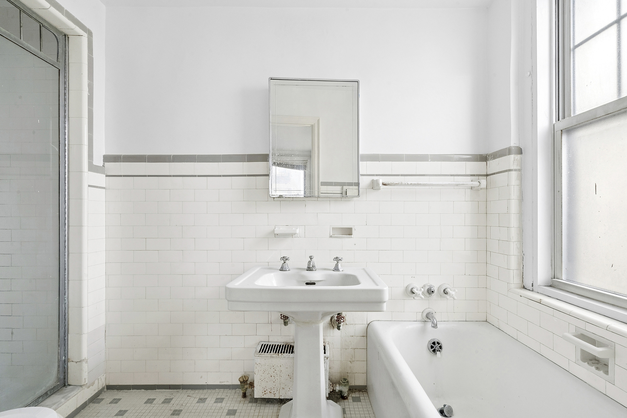 12 West 96th Street, Unit 9A Manhattan, NY 10025 - Photo 10 of 14 a bathroom with a sink and a mirror