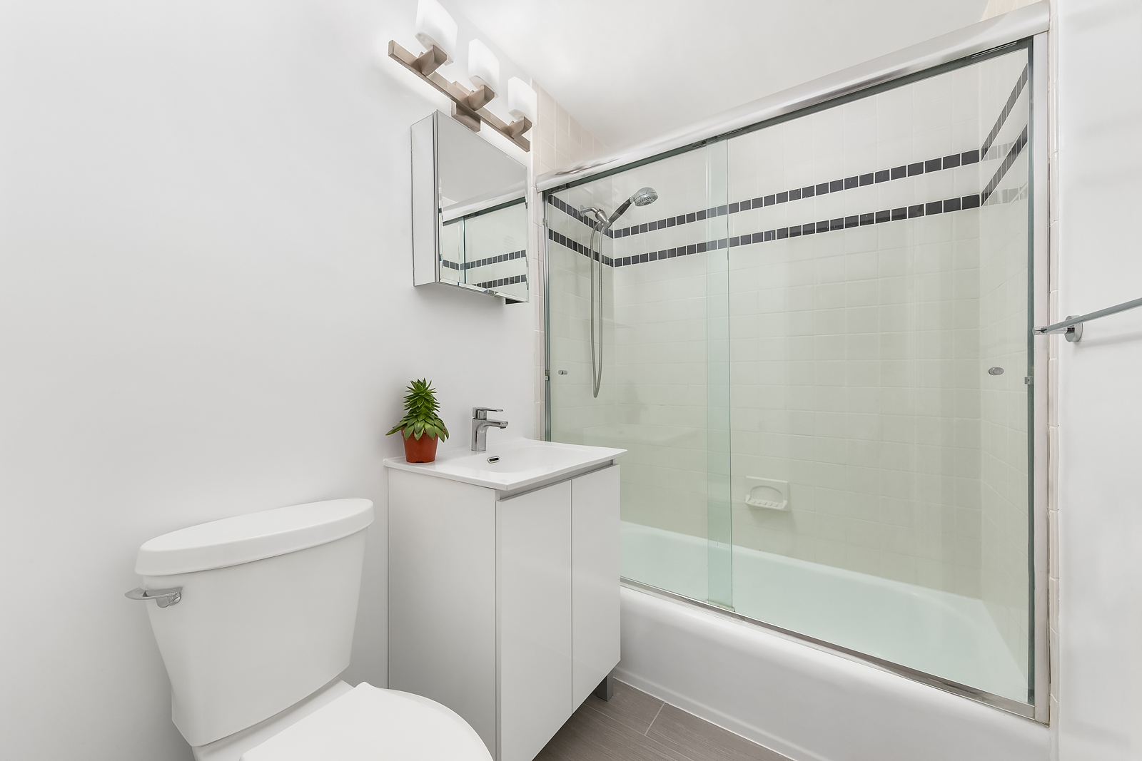 251 East 32nd Street, Unit 5J Manhattan, NY 10016 - Photo 7 of 15 a bathroom with a sink a toilet and shower