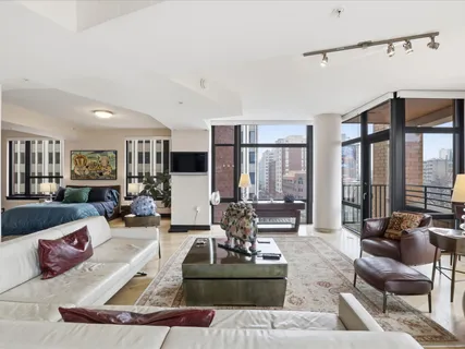 a living room with furniture or couch and a large window