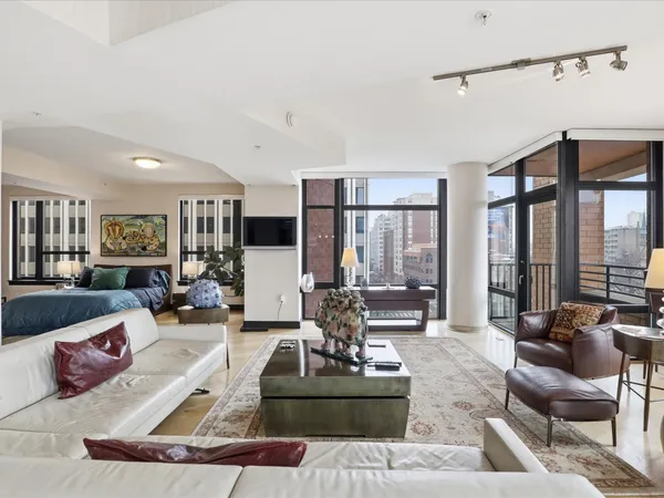 a living room with furniture or couch and a large window