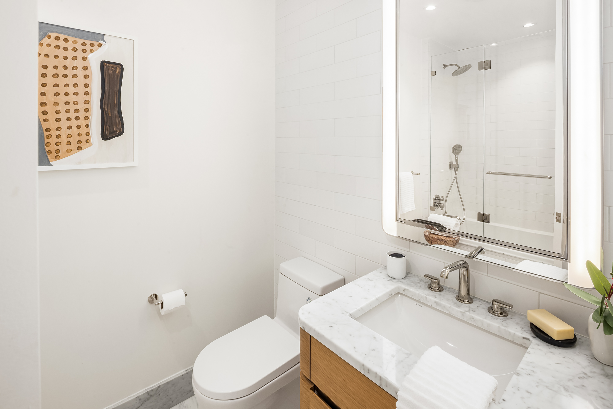 110 Charlton Street, Unit 17E Manhattan, NY 10014 - Photo 17 of 20 a bathroom with a sink toilet and vanity