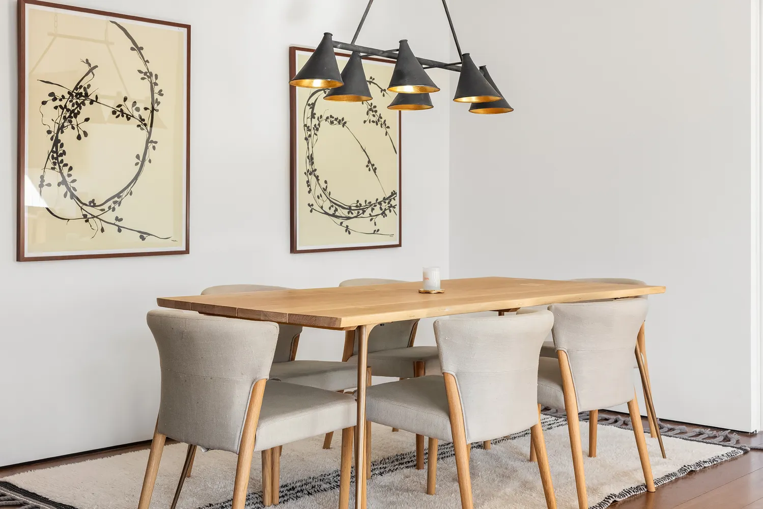 a view of a dining room with a table and chairs