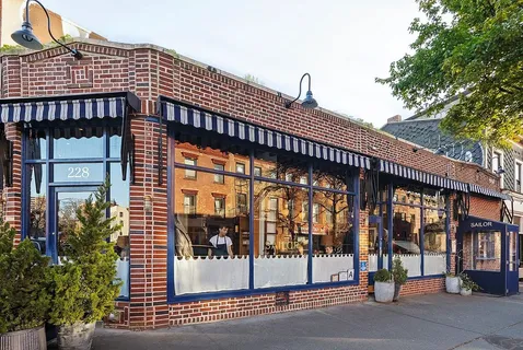 a view of a building with a door and deck