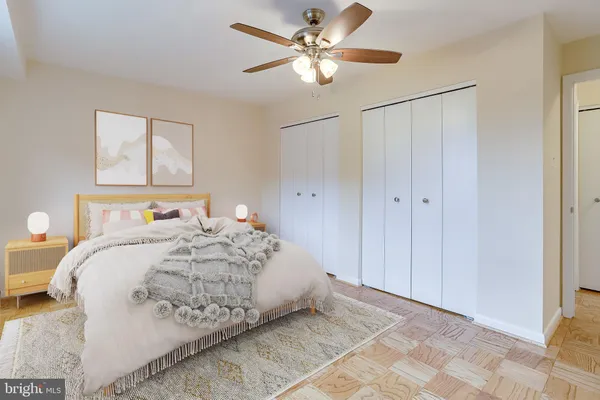 an empty room with window and a chandelier fan