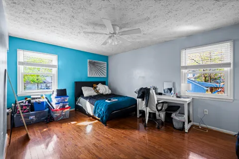 a bedroom with furniture and a wooden floor