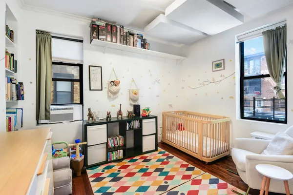 a bedroom with furniture and a book shelf