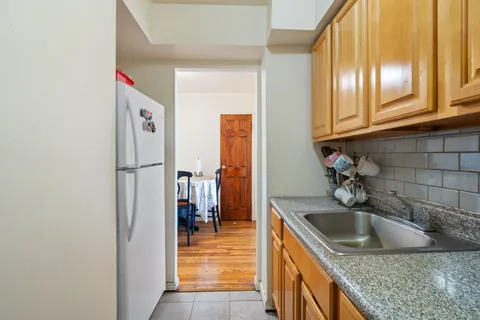 a kitchen with a sink and a refrigerator