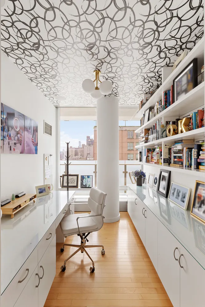 a living room with furniture and a book shelf
