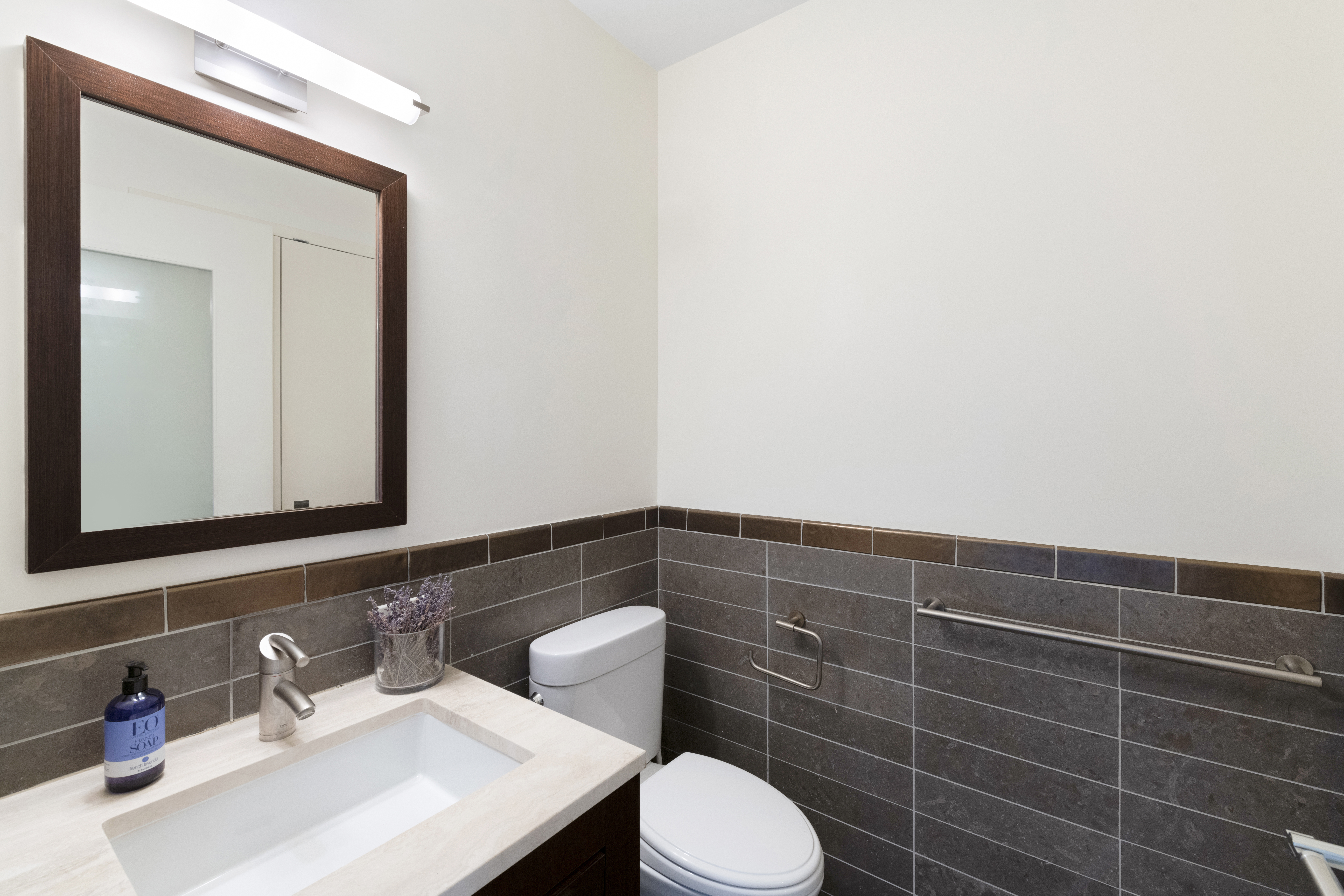101 West 24th Street, Unit 12C Manhattan, NY 10011 - Photo 7 of 17 a bathroom with a sink a toilet and mirror