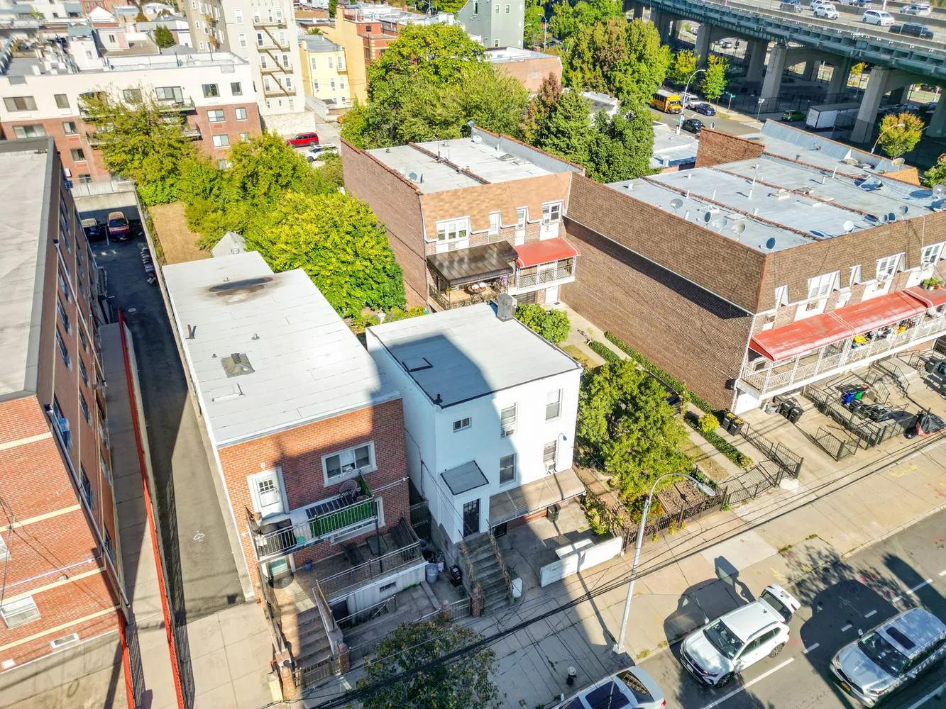 an aerial view of a residential apartment building with a yard