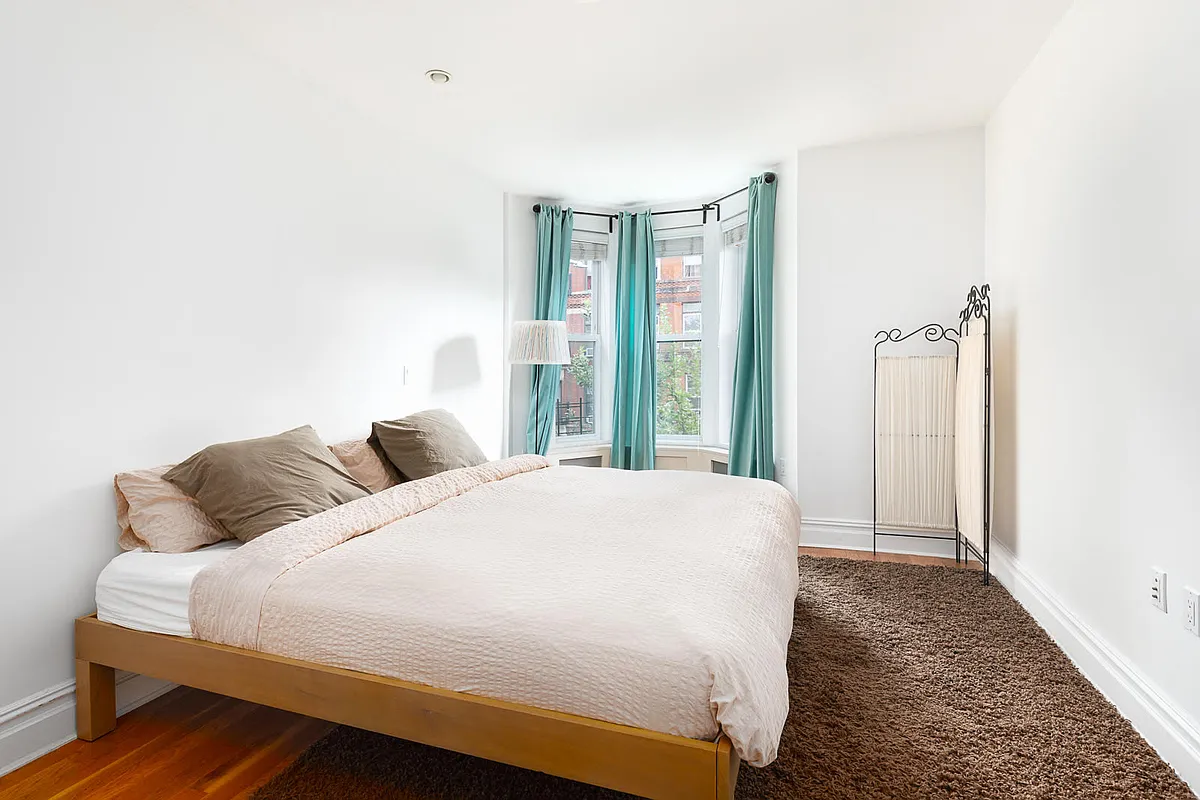 356 12th Street, Unit 2A Brooklyn, NY 11215 - Photo 4 of 7 a bedroom with a large bed and a window