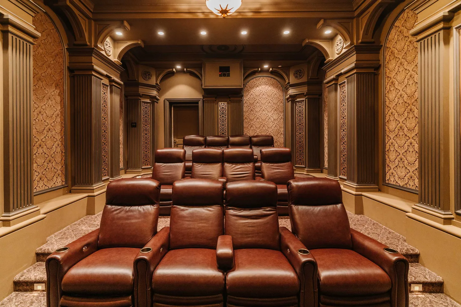 a media room with lots of chairs and a projector