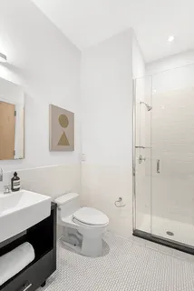 a bathroom with a sink toilet vanity and shower