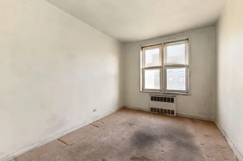 an empty room with a empty space and windows