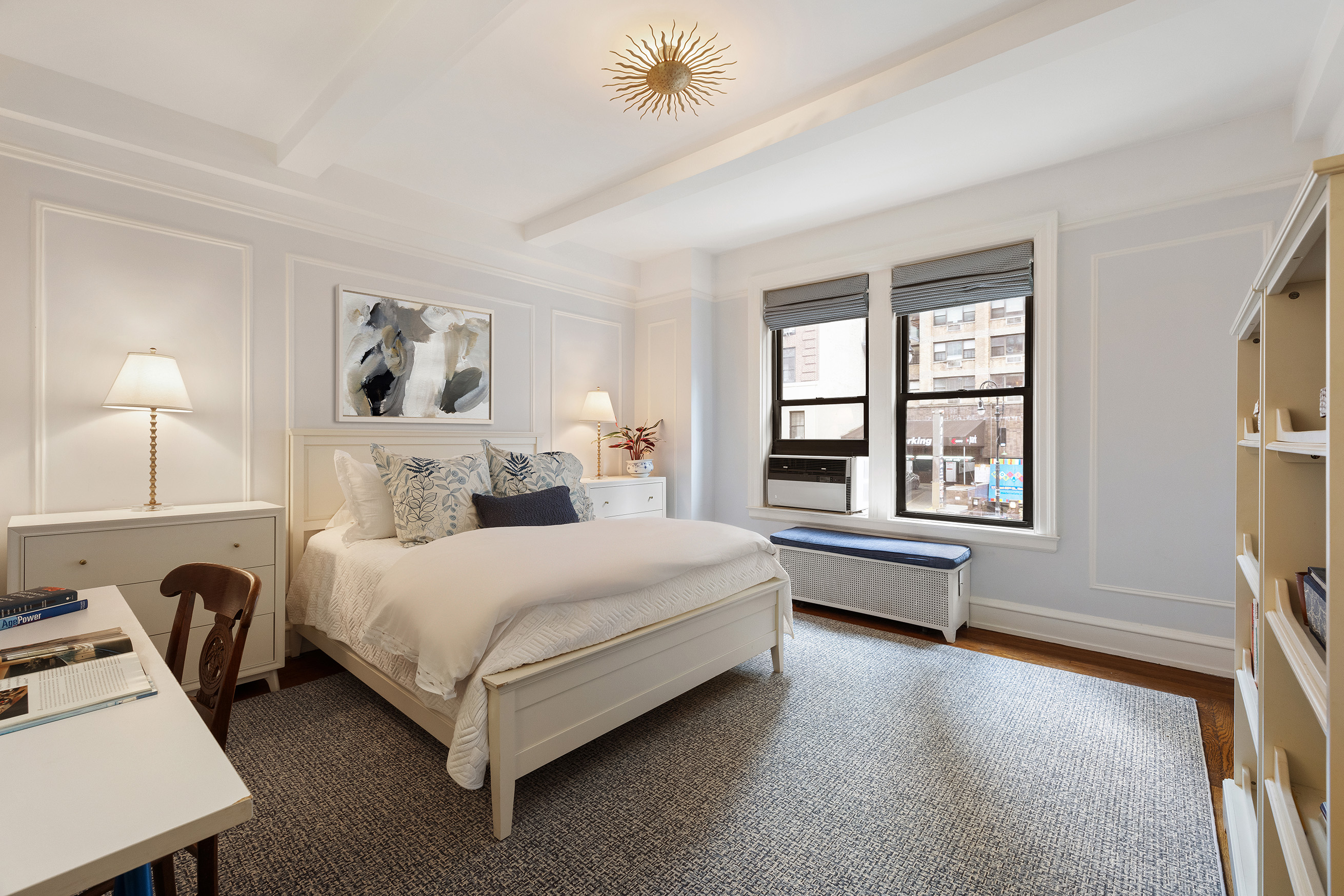 115 East 86th Street, Unit 22 Manhattan, NY 10028 - Photo 10 of 16 a spacious bedroom with a bed a dresser next to a window