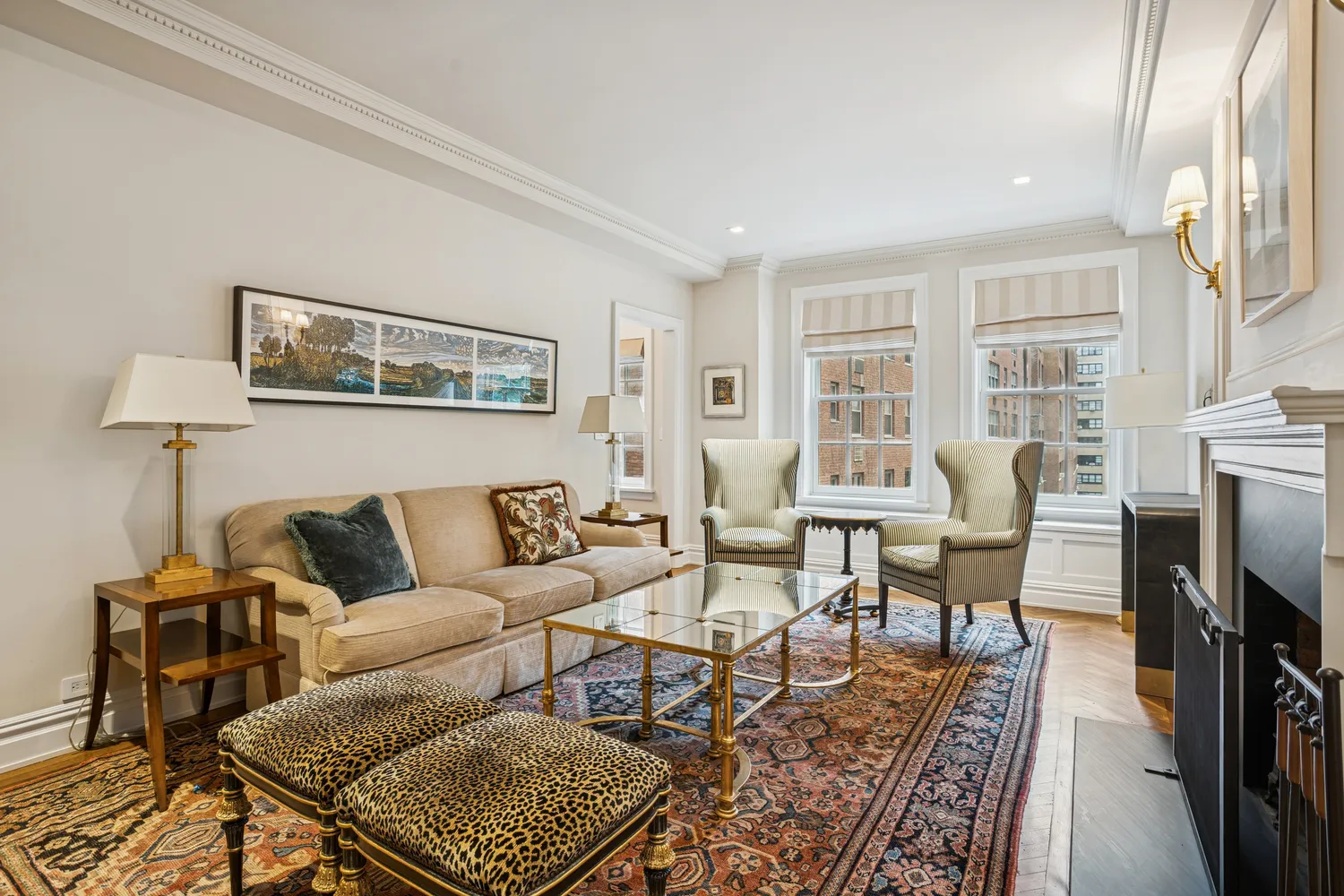 a living room with furniture a fireplace and a table