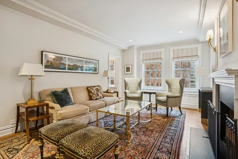 a living room with furniture a fireplace and a table