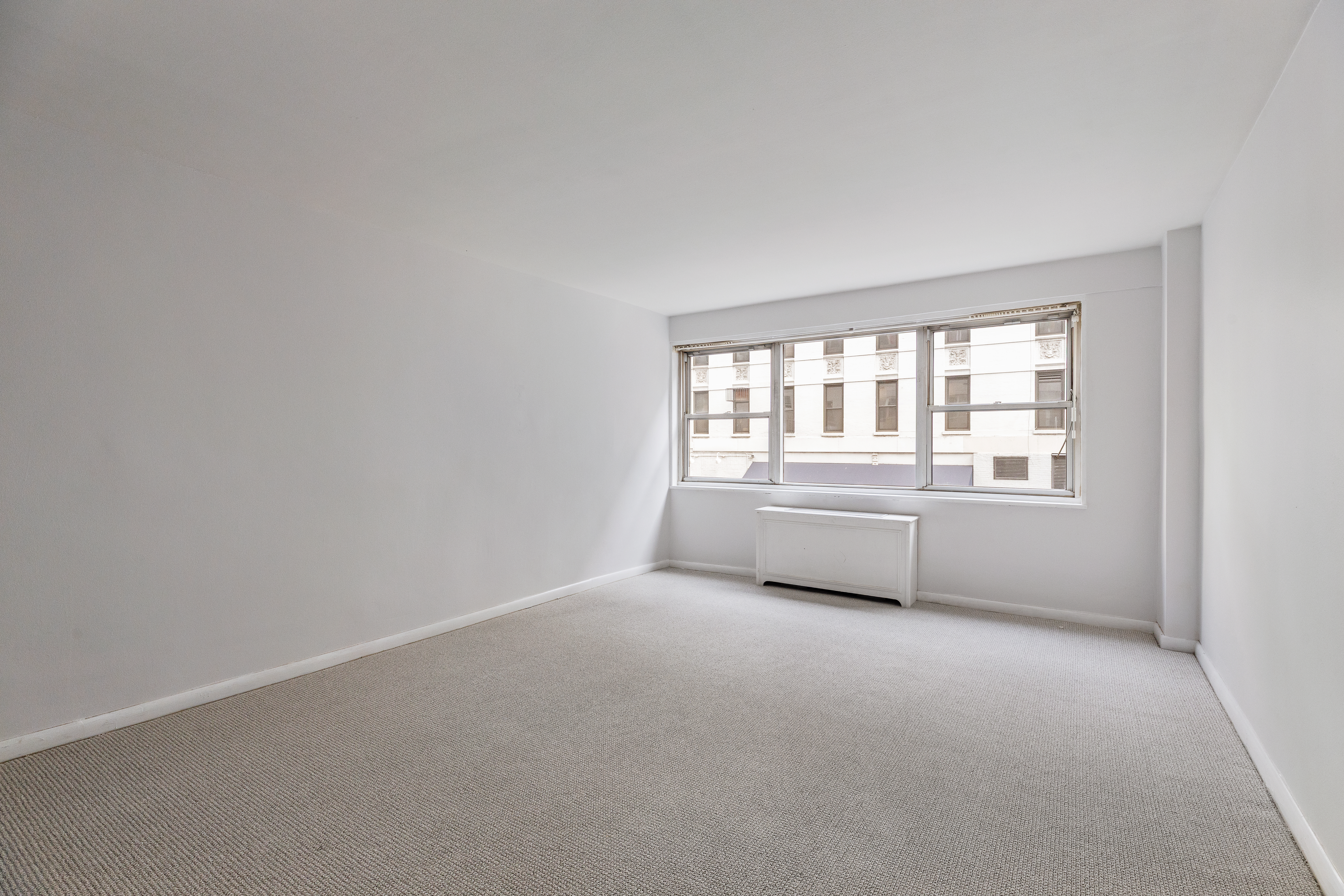 201 East 66th Street, Unit 2E Manhattan, NY 10065 - Photo 8 of 15 a view of an empty room with a window
