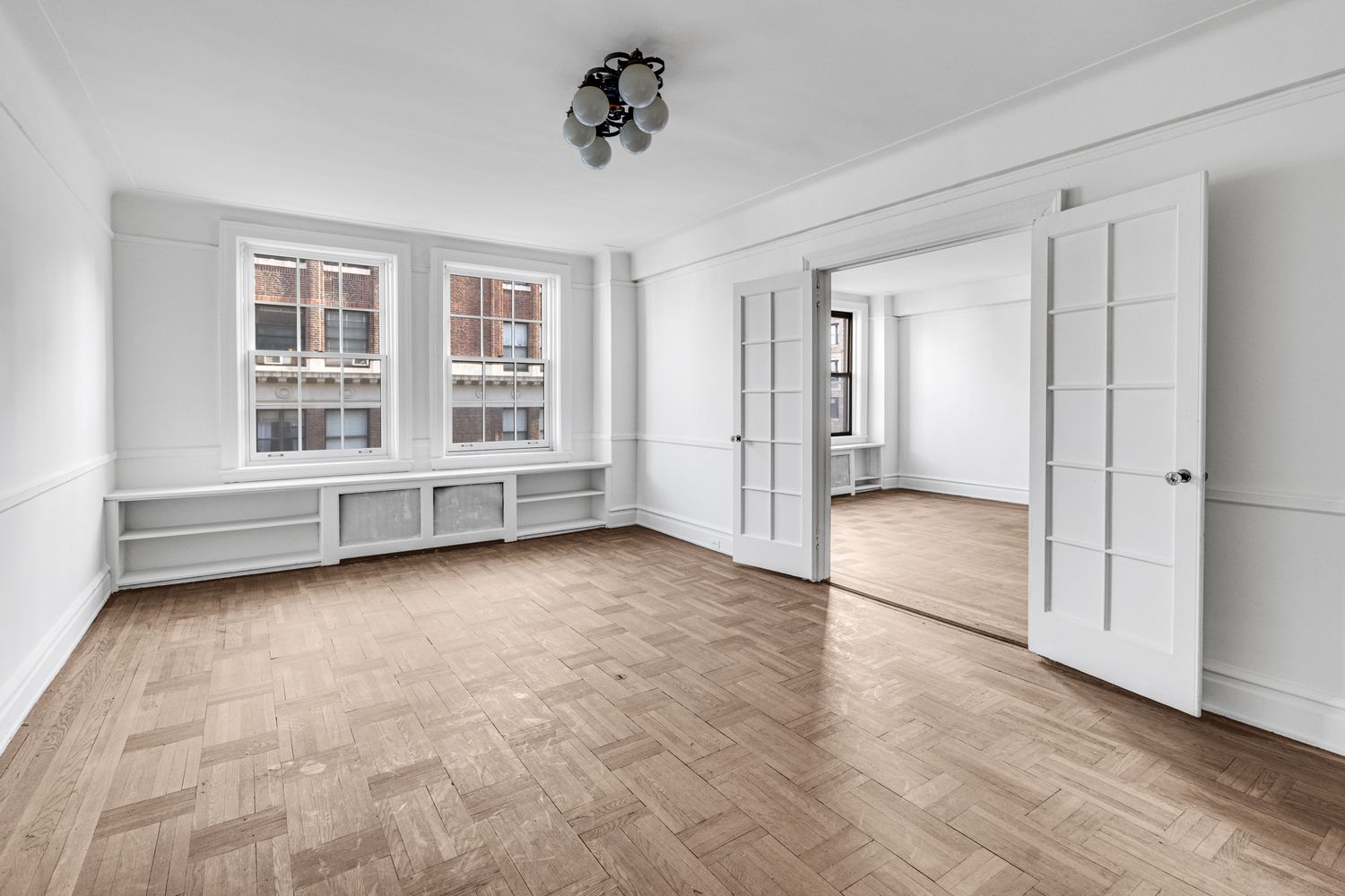 473 West End Avenue, Unit 12A Manhattan, NY 10024 - Photo 2 of 21 a view of an empty room with a window and wooden floor