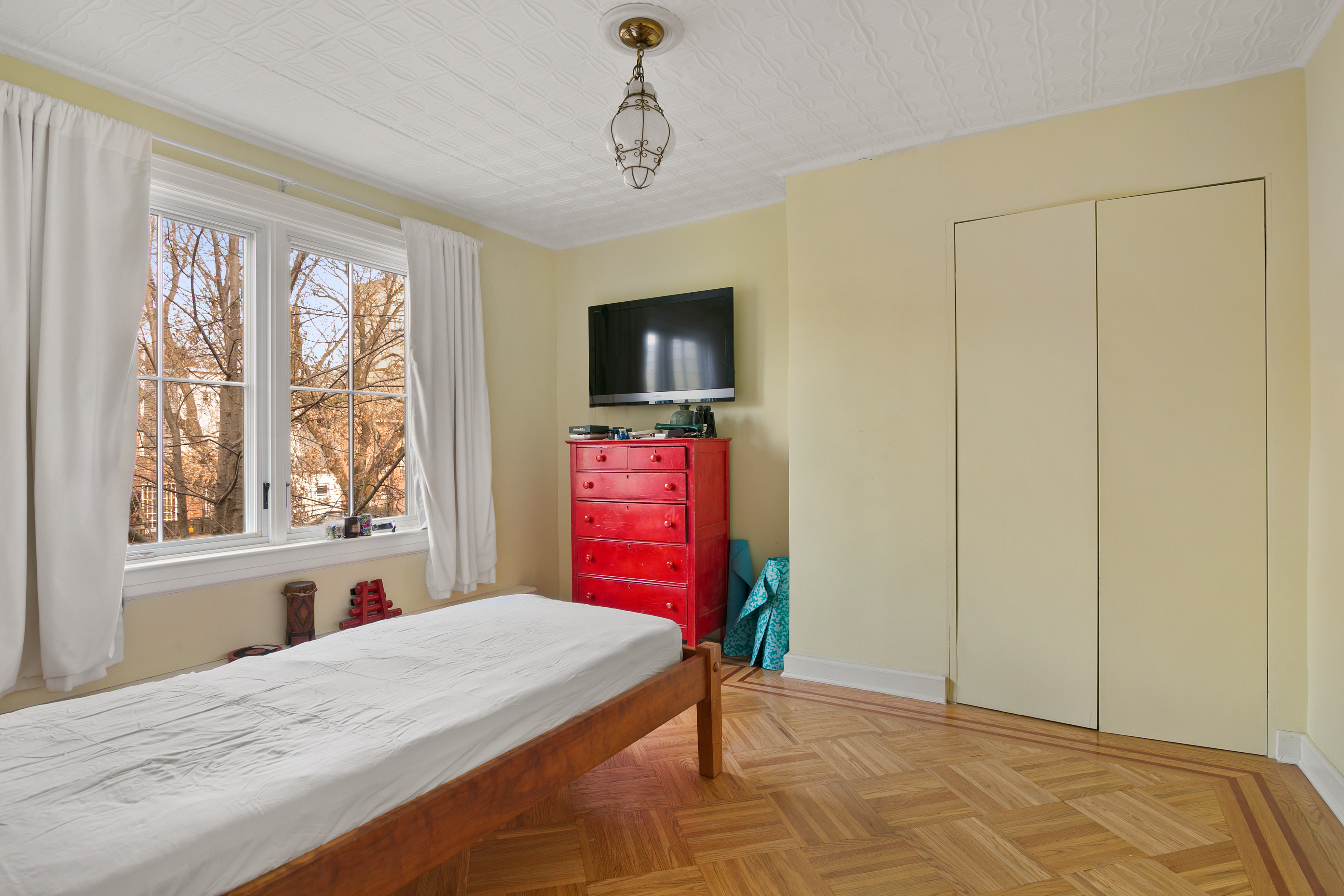 291 14th Street Brooklyn, NY 11215 - Photo 7 of 10 a bedroom with a bed dresser and a window
