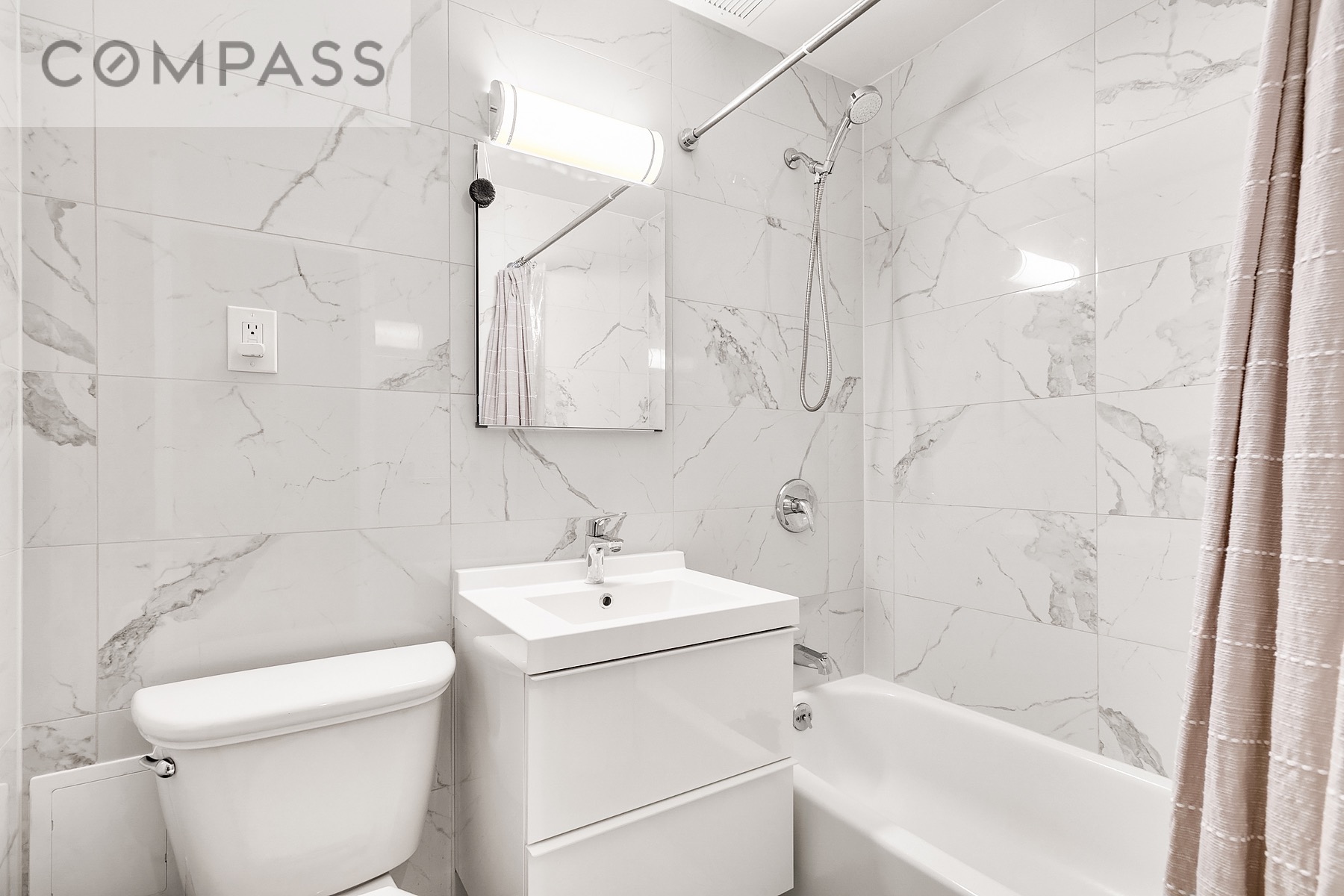 250 Mercer Street, Unit C309 Manhattan, NY 10012 - Photo 6 of 8 a bathroom with a sink a toilet and shower