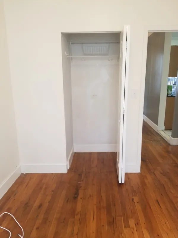 an empty room with wooden floor