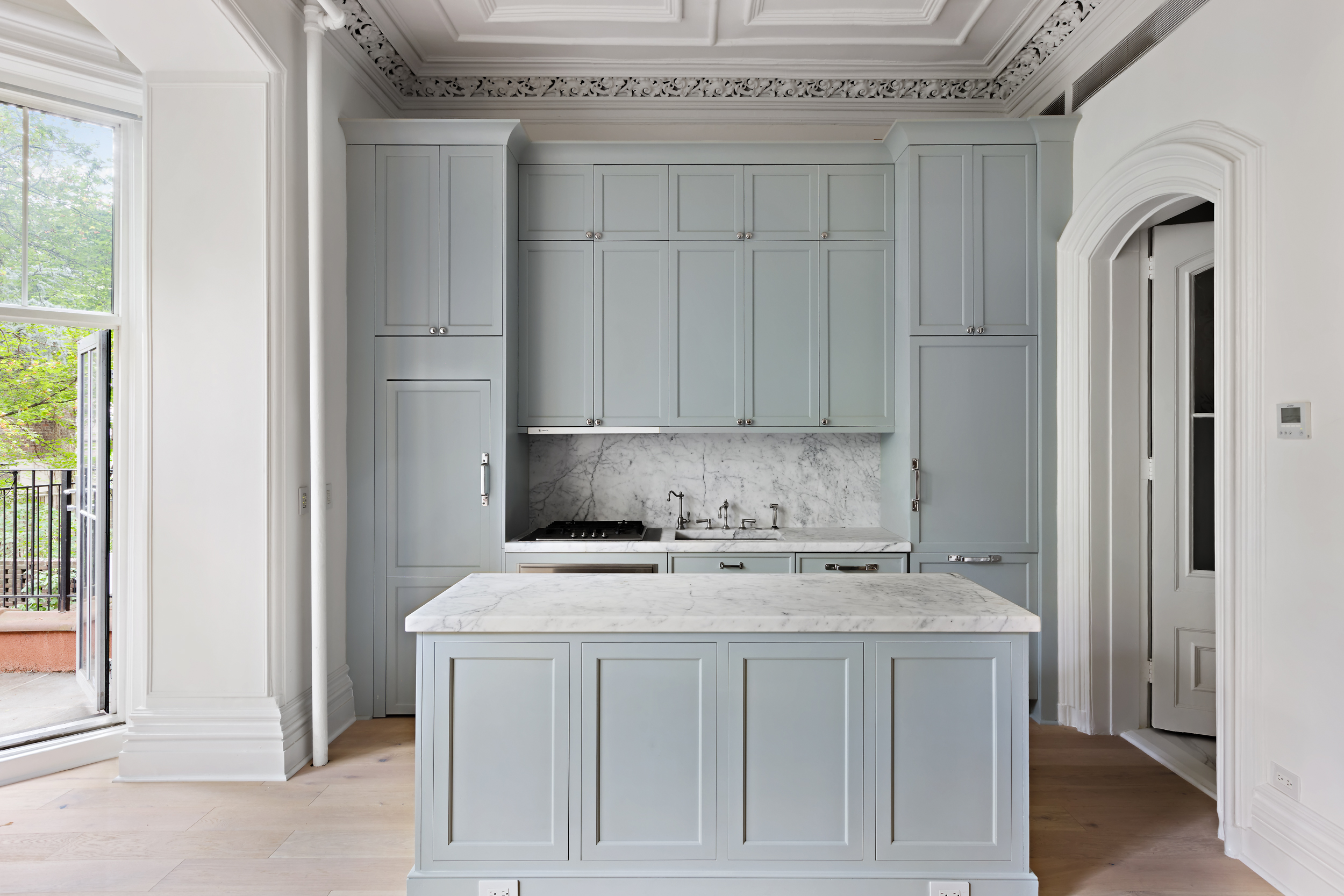 427 West 21st Street, Unit PARLOR Manhattan, NY 10011 - Photo 8 of 19 a kitchen with cabinets and a stove top oven