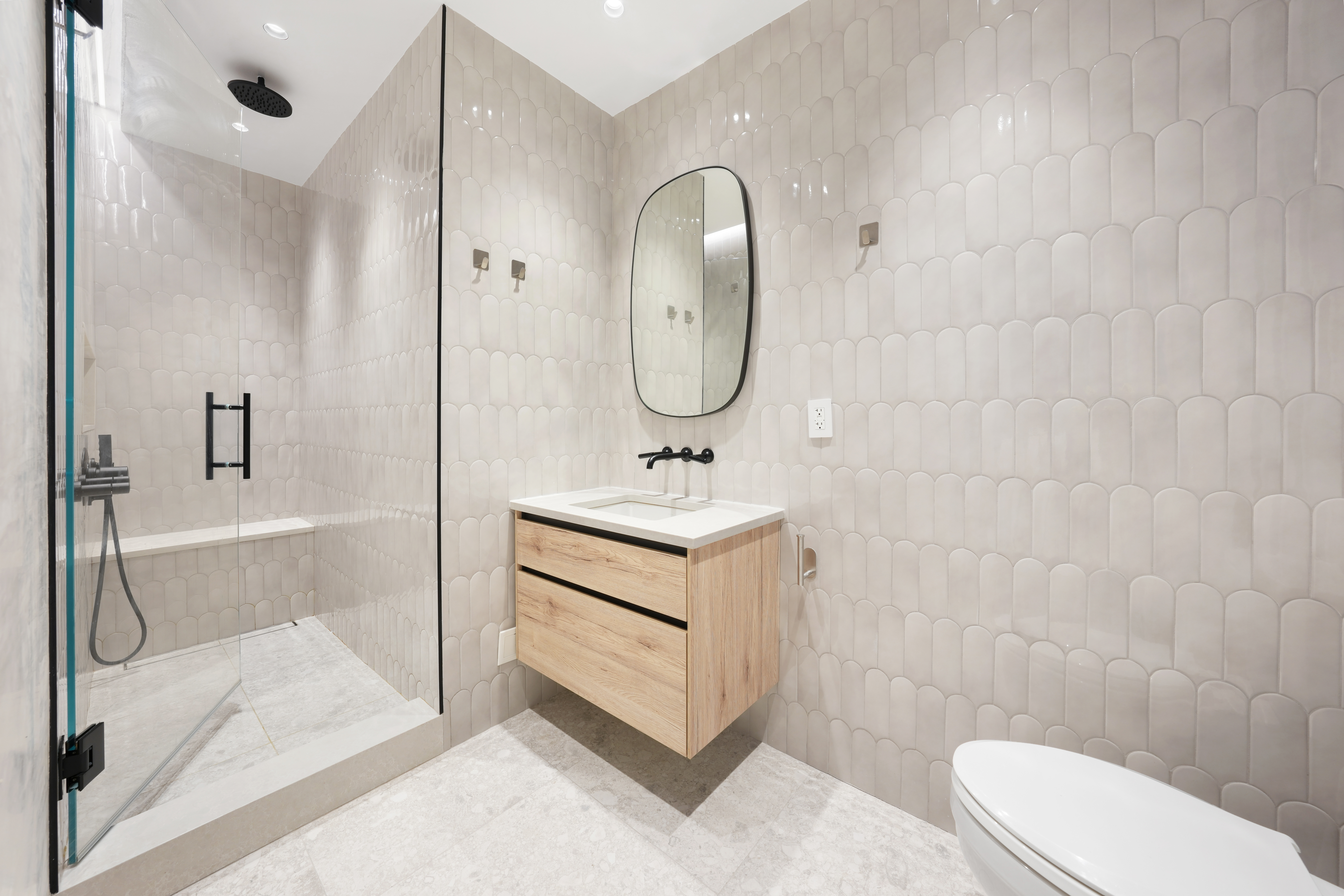 176 West 87th Street, Unit 1H Manhattan, NY 10024 - Photo 11 of 19 a bathroom with a sink toilet and shower