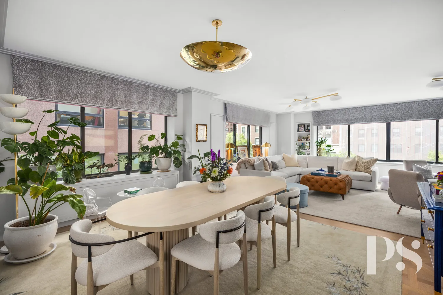 a view of a dining room with furniture and a potted plant