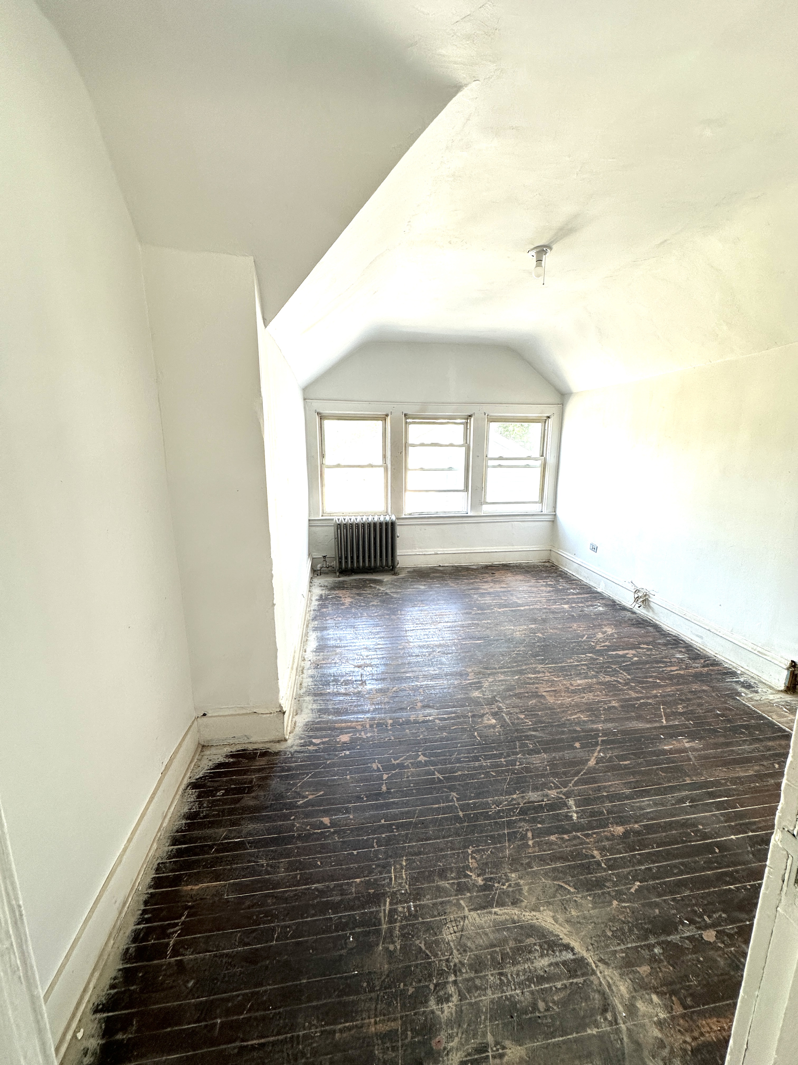 92-64 Springfield Boulevard Queens, NY 11428 - Photo 22 of 25 a view of empty room with wooden floor and fan